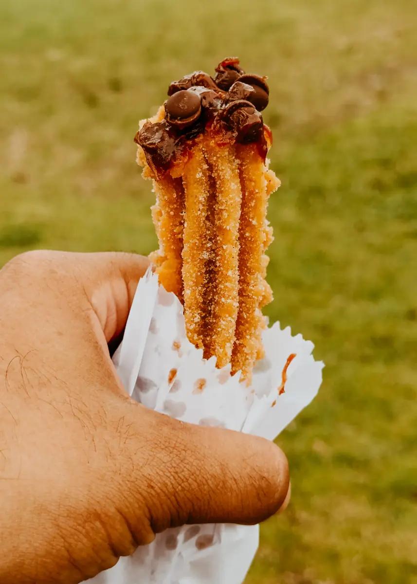 A cinnamon churro drizzled with caramel